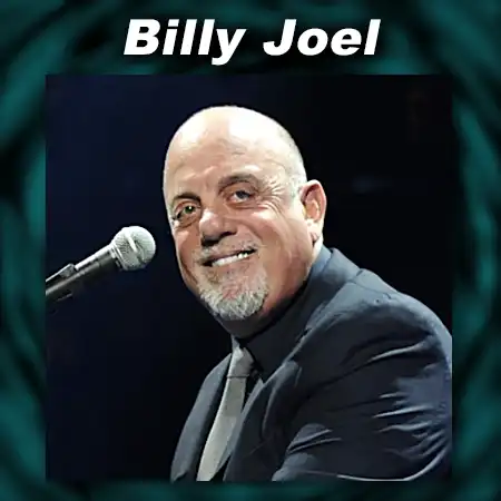 Billy Joel smiling in front of microphone